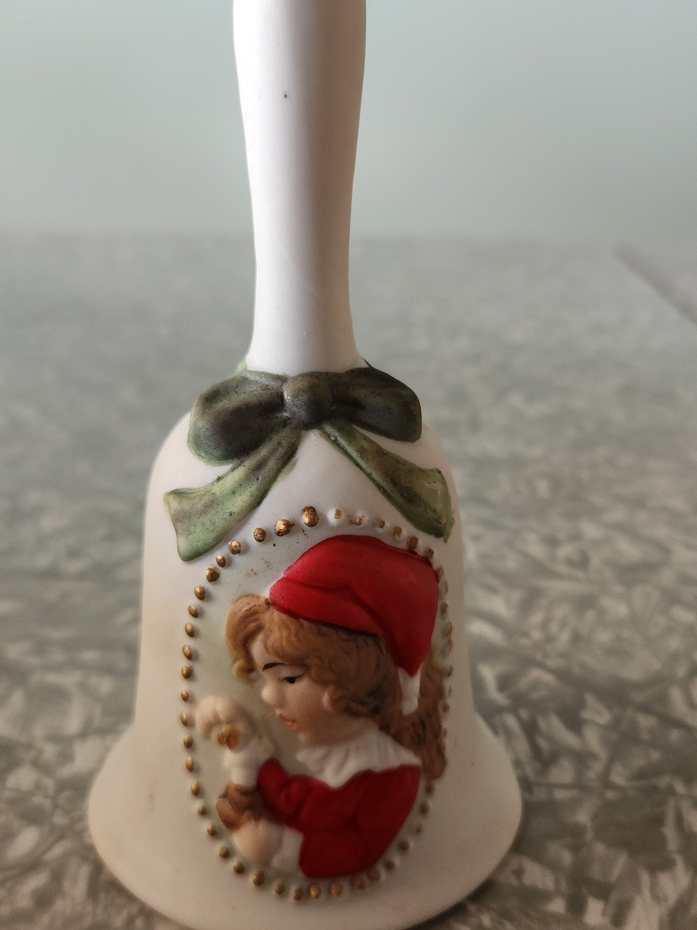 White Ceramic Holiday Bell with Girl and Green Bow – Festive Table Accent